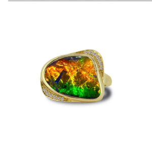 A striking natural Queensland gem-grade boulder opal ring showcasing brilliant green, gold and fiery orange play of colour, framed in 18k yellow gold with diamond accents. A timeless statement ring celebrating the beauty of Australian boulder opal.