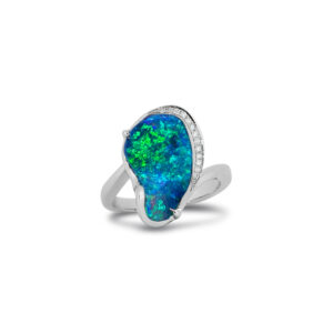 Brilliant blue and vivid green fire bring this boulder opal to life, beautifully showcased in an 18k white gold ring surrounded by diamonds. A striking expression of Australian craftsmanship.
